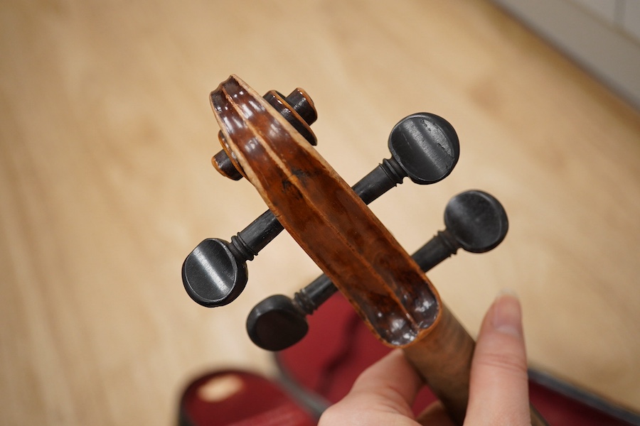 Two cased violins; one French 19th century bearing a hand written label for Francesco Werentle 1746, body length 35.5cm, the other an early 20th century violin, body length 35cm. Condition - poor.